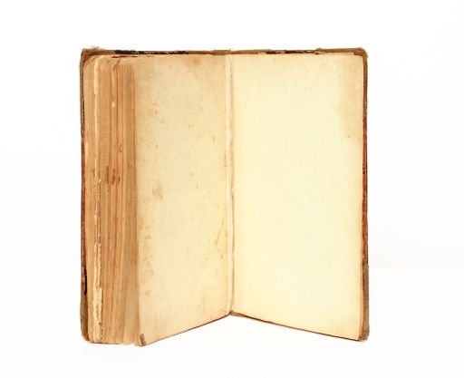 A closeup shot of an open old books isolated on white background - copy space