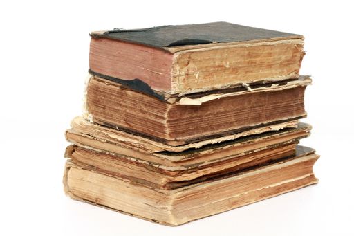 A closeup shot of piled old  books isolated on a white background