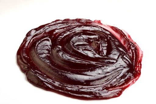 A closeup high angle shot of jam mass on a white surface