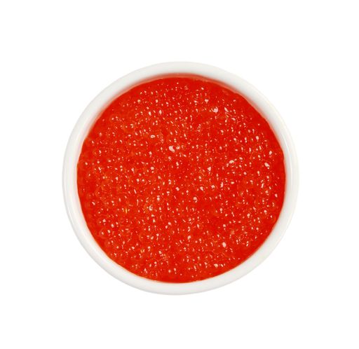 A vertical top view shot of caviar on a white surface