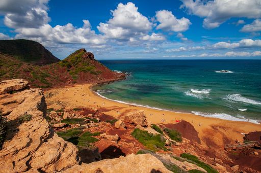 A beautiful sandy beach and a sea with crystal water on a sunny day