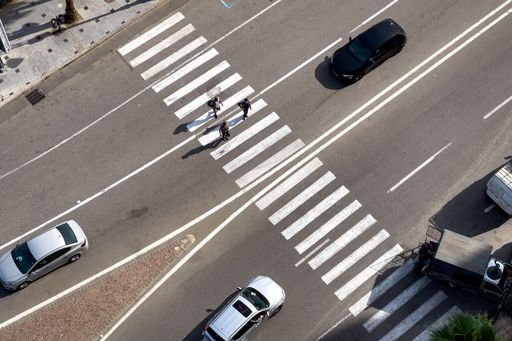 An aerial view of Pedestrians crossing the zebra lines