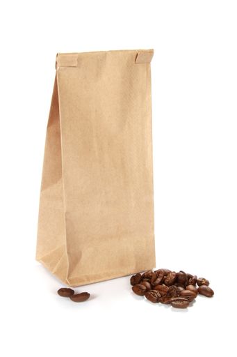 A vertical shot of coffee beans by a paper bag