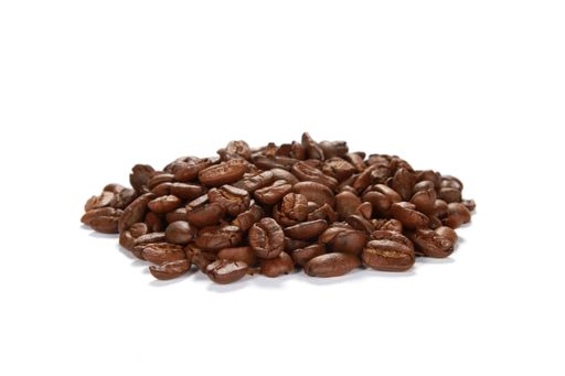 A closeup shot of a pile of coffee beans isolated on a white background