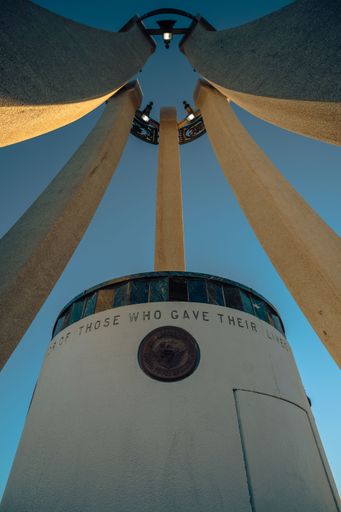 The vertical low-angle view from inside the Veterans Memorial before the blue sky