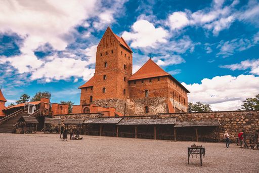 A beautiful shot of an old castle made of bricks on the cloudy sky background