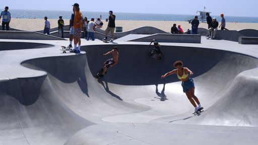 A group of people skateboarding at Venice beach in Los Angeles, United States