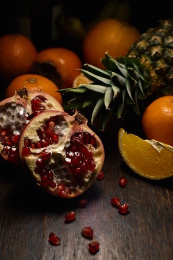 A vertical shot of different tropical fruits on a wooden surface