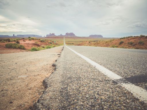 A beautiful view of rocky cliffs under a cloudy sky in Monument Valley, Utah, USA