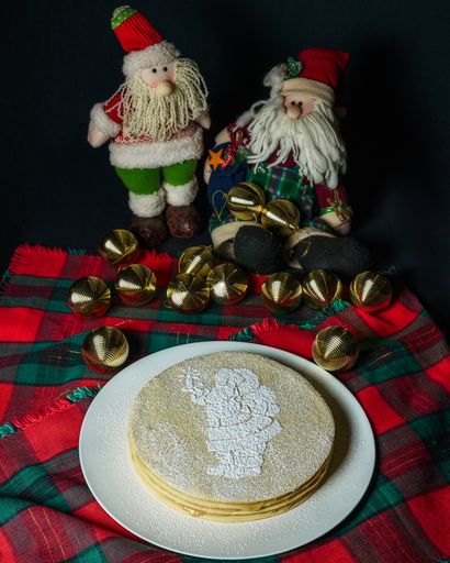 A vertical shot of tasty pancakes with a Santa on it - Holidays concept