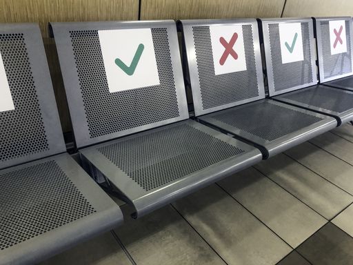 Metal seats with green yes and red no signs