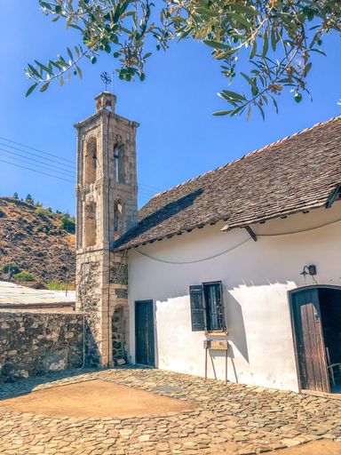 A vertical shot of a house with tower under blue skz