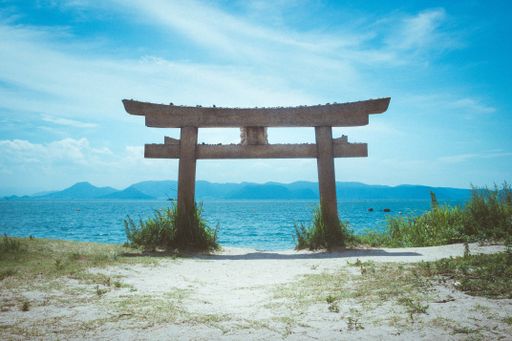A low angle shot of a torii at a beach in Naoshima Island, Japan during summer