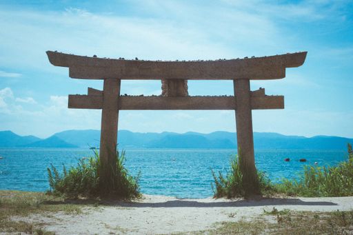 A low angle shot of a torii at a beach in Naoshima Island, Japan during summer