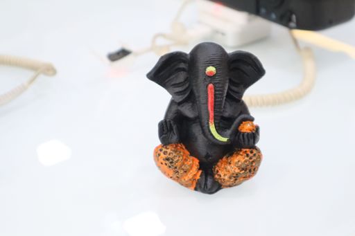 A closeup of a black statue of an elefant on a white background