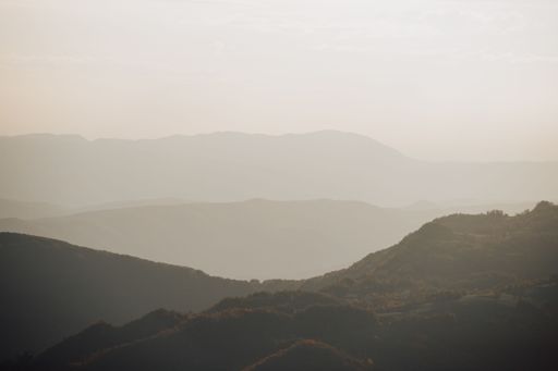 A mesmerizing shot of the golden hour, the silhouette of foggy mountains in Durmitor, Montenegro