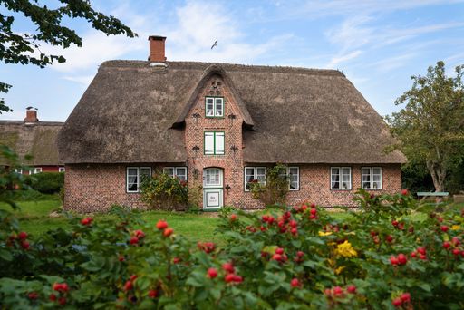 NEBEL, GERMANY - SEPTEMBER 29, 2020: Panoramic image of a traditional Frisian house against blue sky on September 29, 2020 on Amrum, Germany