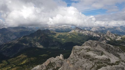 An aerial of the mountain peaks of Italian Dolomites hiding behind the fog