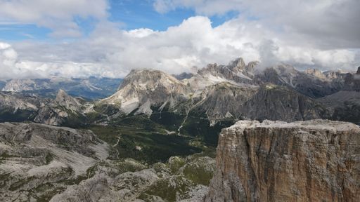 An aerial of the mountain peaks of Italian Dolomites hiding behind the fog