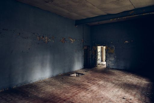 An interior shot of an old building deteriorating over time
