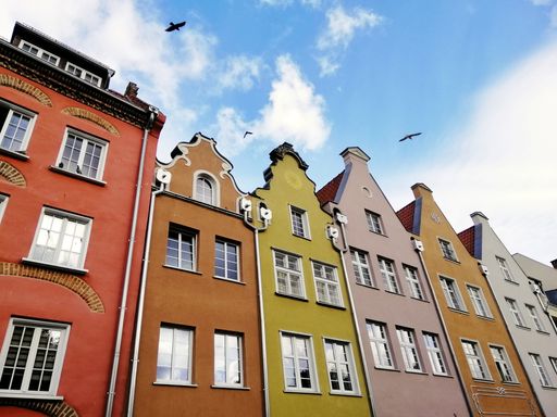 A low angle shot of typical colorful buildings in the old town of Gdansk, Poland under a cloudy sky