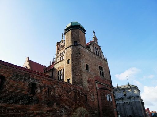 A low angle shot of a traditional historic building in the old town of Gdansk, Poland under a cloudy sky