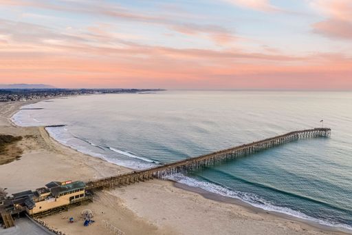 Purple sunset sky over Ventura beach with a long pier, California, USA