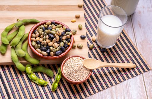 A top view of fresh soybean pods edamame soybeans with granulated soy lecithin and soy milk