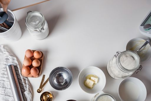 A top view shot of baking ingredients on a white table