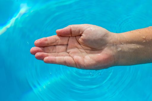 A shot of a wet hand on a water background