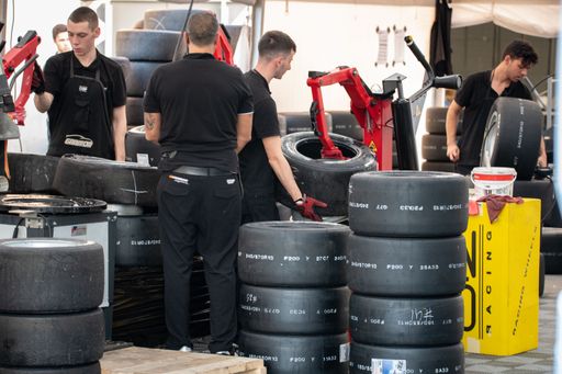 The young mechanic apprentices changing tires for racing cars