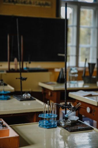 A vertical shot of an interior of an old empty chemistry class laboratory desk in a school