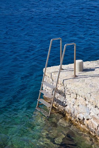A vertical shot of stairs going down to the sea in Symi island, Greece