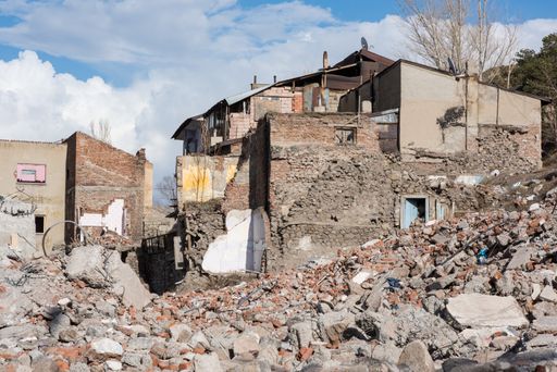 A view of rubbles beside brick houses at an impoverished area