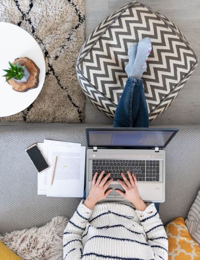 A vertical top view of a female working with a laptop