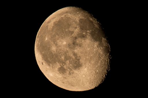 The moon in the dark sky. Waning Gibbous.