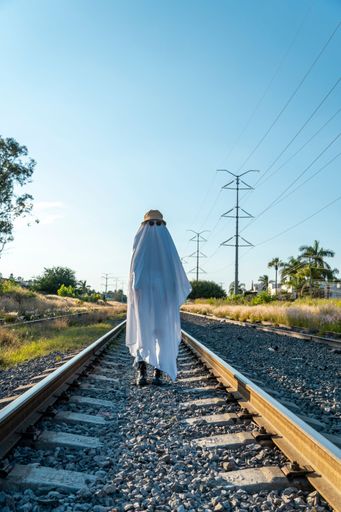 A ghost standing on the railway tracks in the countryside