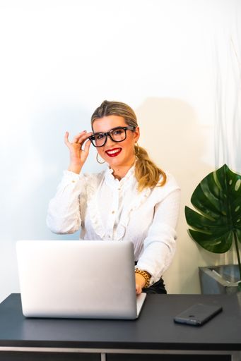A closeup of a young successful businesswoman working on the laptop