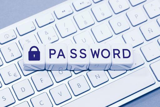Password word and Closed padlock icon on cube blocks on computer keyboard. Computer data protection concept
