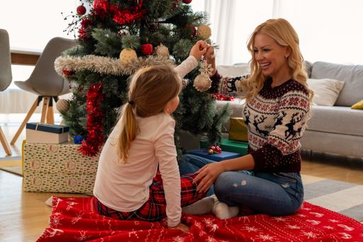 A closeup of a happy mother having fun with her daughter, Christmas mood in a cozy house