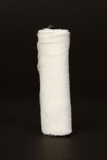 A vertical closeup shot of a bandage on a black surface