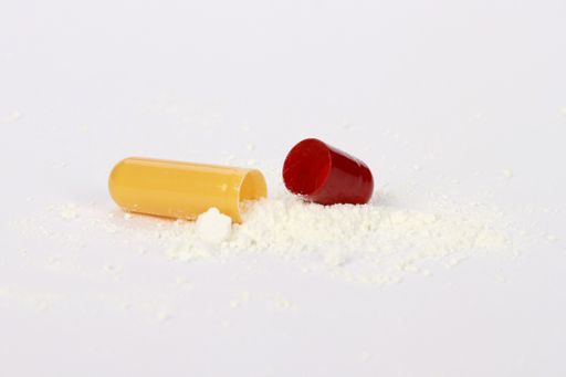 A closeup shot of tablet with powder isolated on white background
