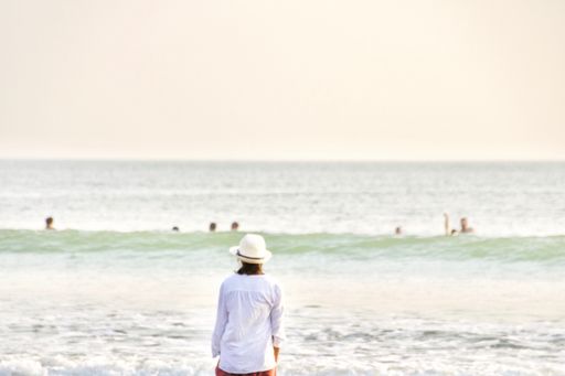 A girl standing in front of ocean at sunset time in Goa,