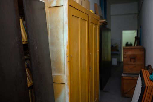 A stockroom with various wooden furniture and materials