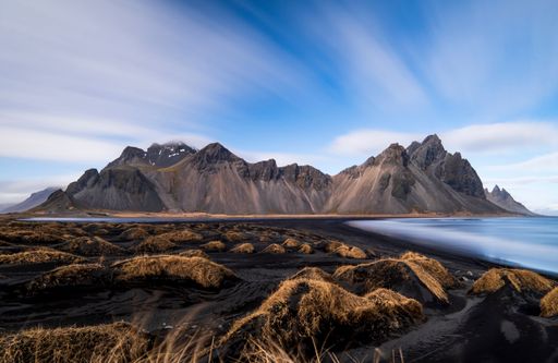 A beautiful landscape scene of the Stokksnes beach surrounded by cliffs in Iceland