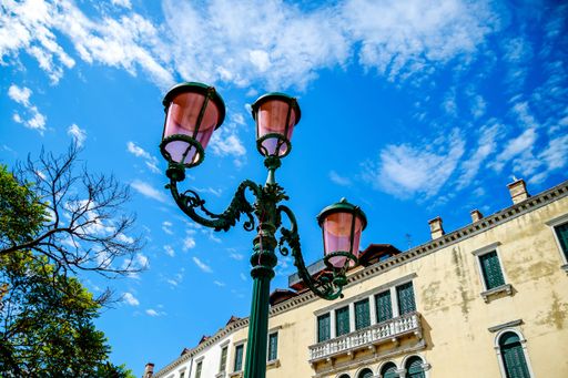 A low-angle shot of the street light against a blue sky