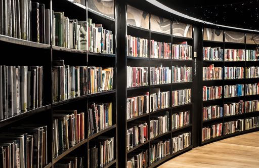 A closeup of book shelves inside Birmingham library light around beige floor