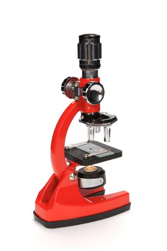 A vertical shot of a red microscope isolated on a white background