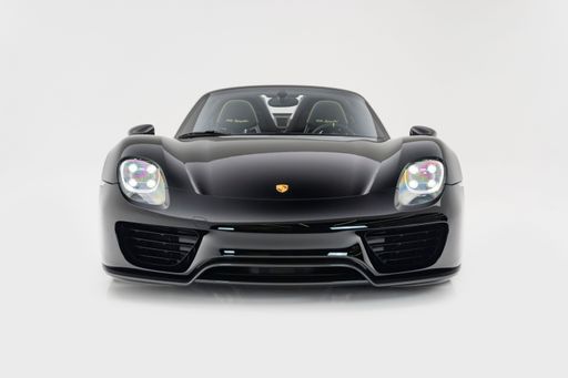A front view of a black Porsche 918 Spyder on a white background