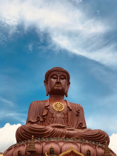 A vertical shot of a statue of Buddha in Kelantan, Malaysia